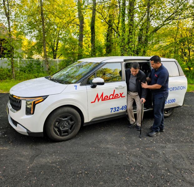 Medex driver helping a rider into a Medex vehicle